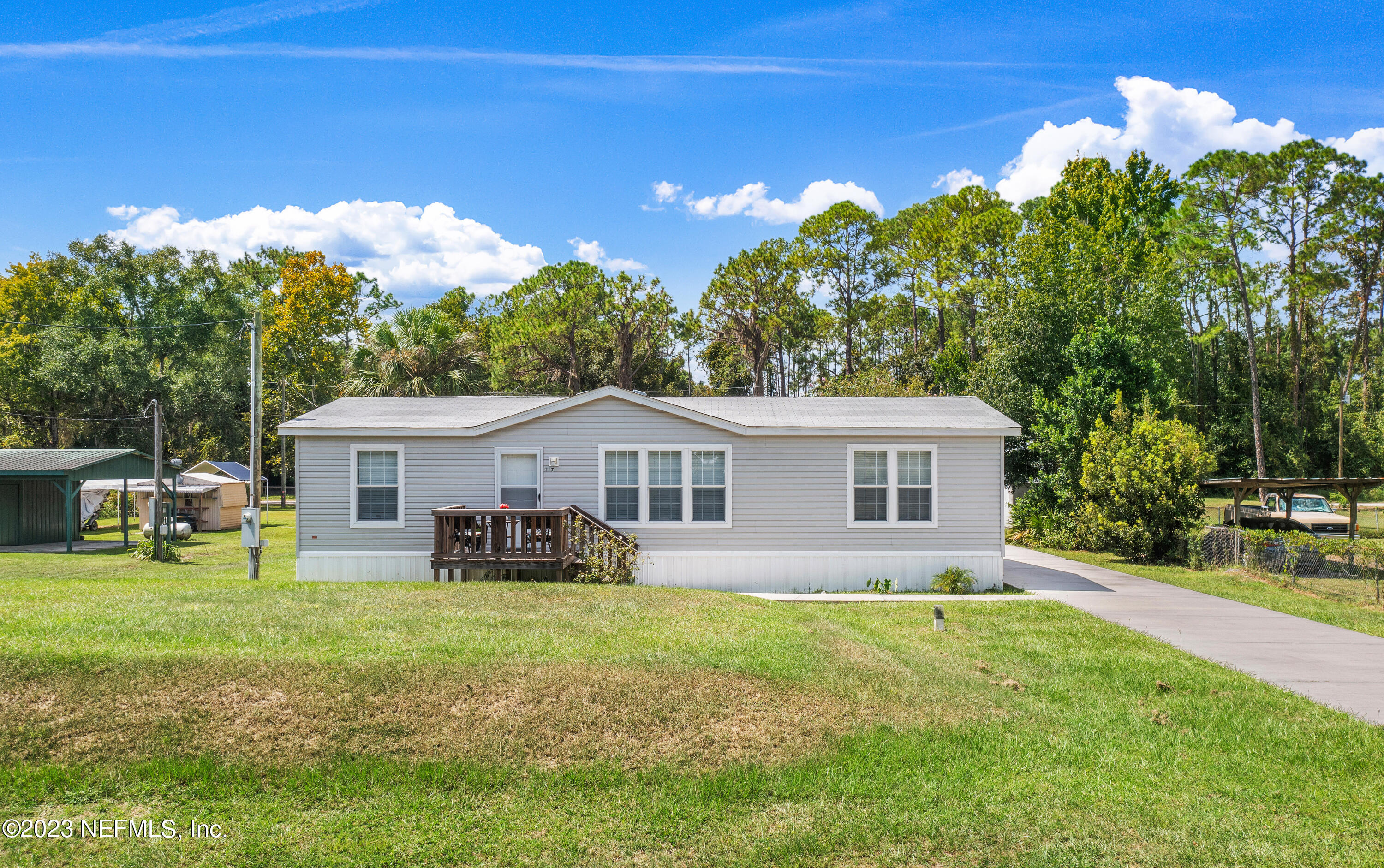 117 Riverside Avenue Satsuma, FL 32189 - Photo 4 of 24 a house view with a sitting space and garden