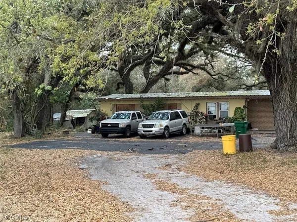 a view of a yard with car parked