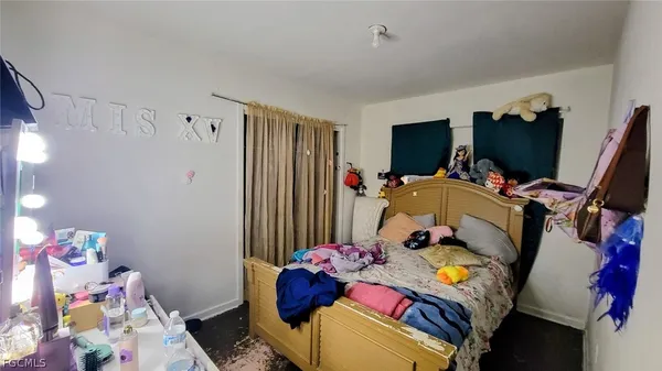 a bedroom with furniture and a flat screen tv