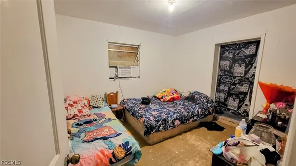 a bedroom with bed and a couch