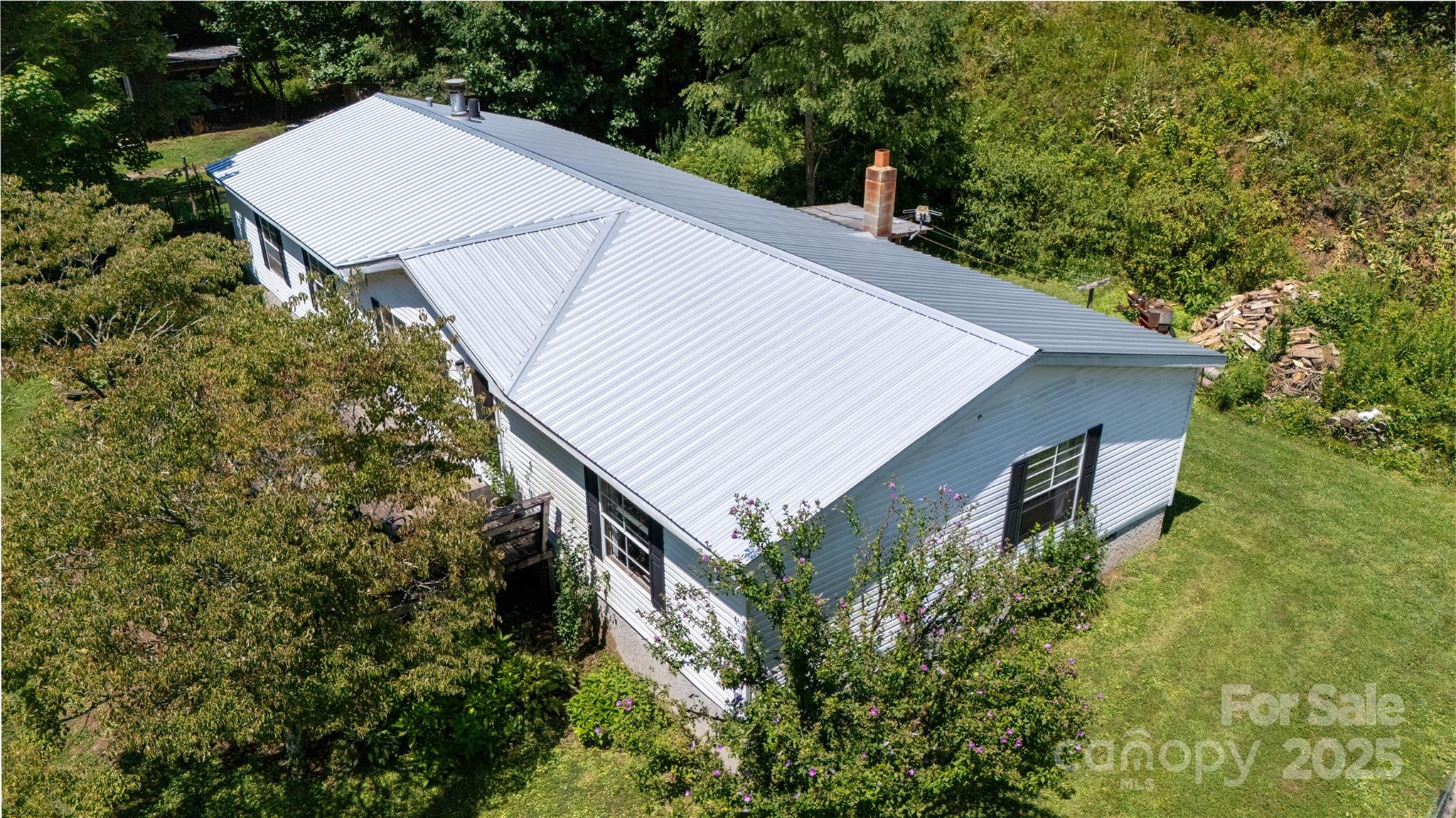 614 Upper Doe Bag Road Green Mountain, NC 28740 - Photo 21 of 44 a aerial view of a house with yard and trees in the background