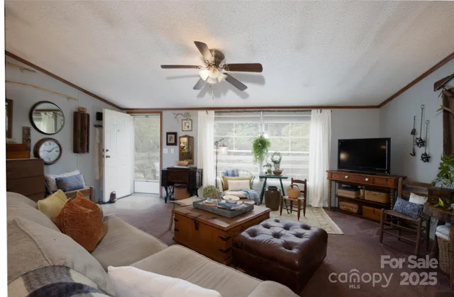 a living room with furniture and a flat screen tv with wooden floor