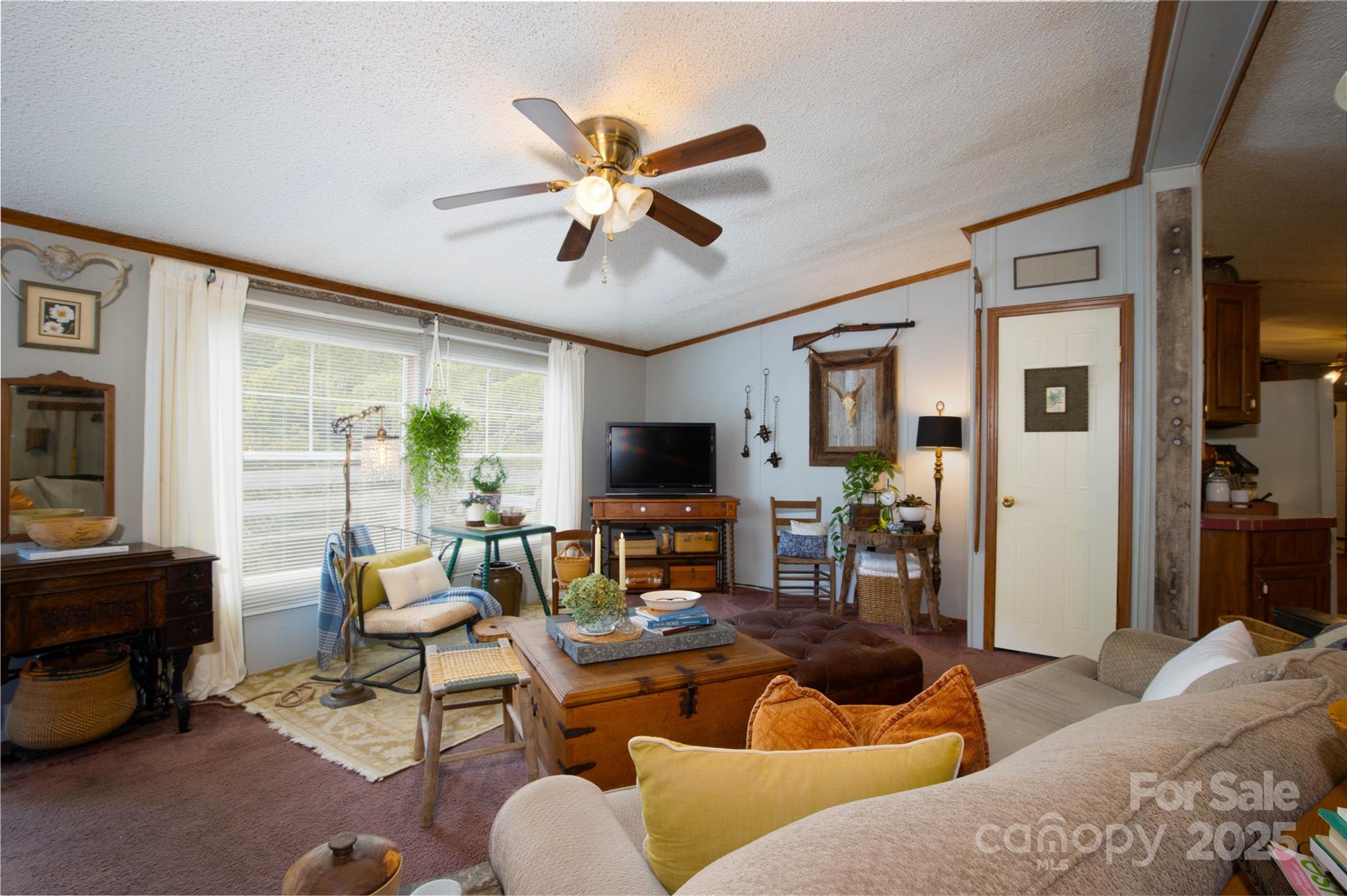 614 Upper Doe Bag Road Green Mountain, NC 28740 - Photo 25 of 44 a living room with furniture and a flat screen tv with wooden floor