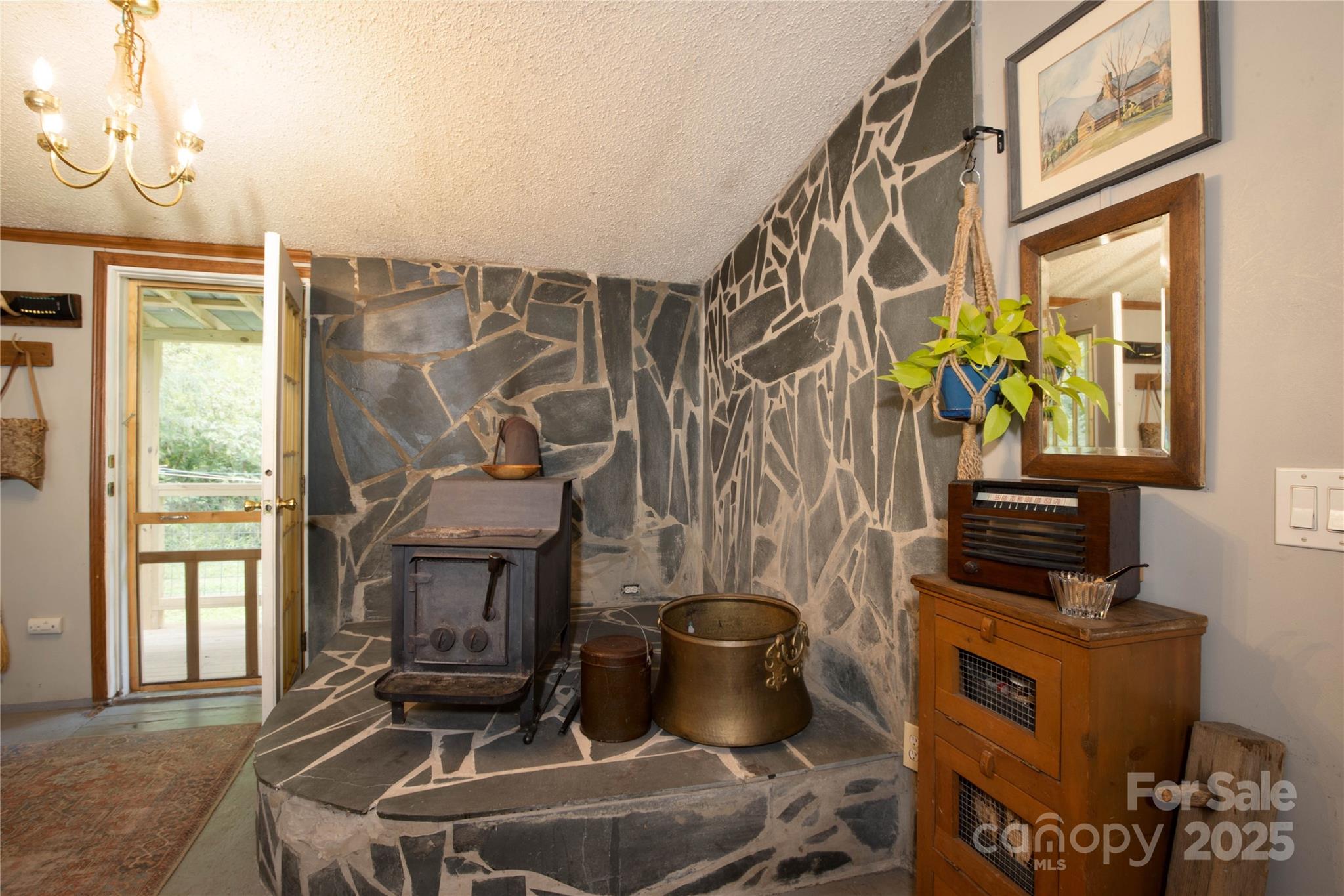 614 Upper Doe Bag Road Green Mountain, NC 28740 - Photo 27 of 44 a living room with furniture a flat screen tv and a fireplace