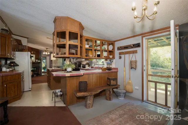 a kitchen with cabinets and chairs