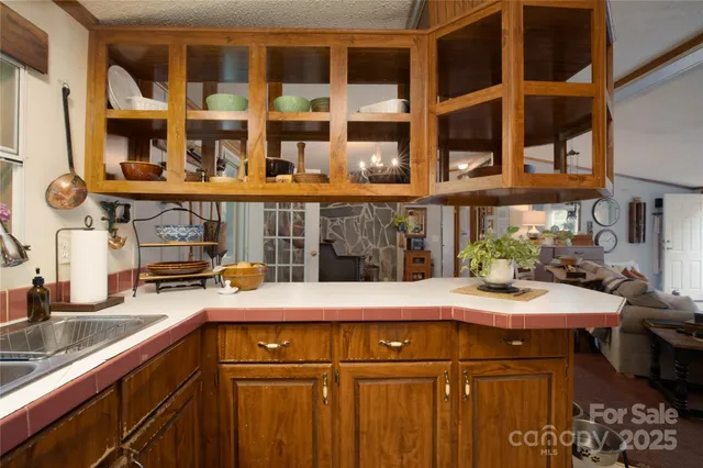 a kitchen with a sink a stove and cabinets