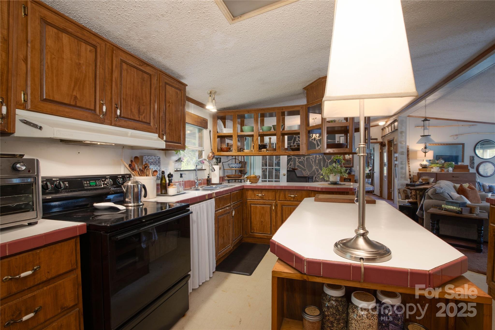 614 Upper Doe Bag Road Green Mountain, NC 28740 - Photo 31 of 44 a kitchen with a sink a stove and cabinets
