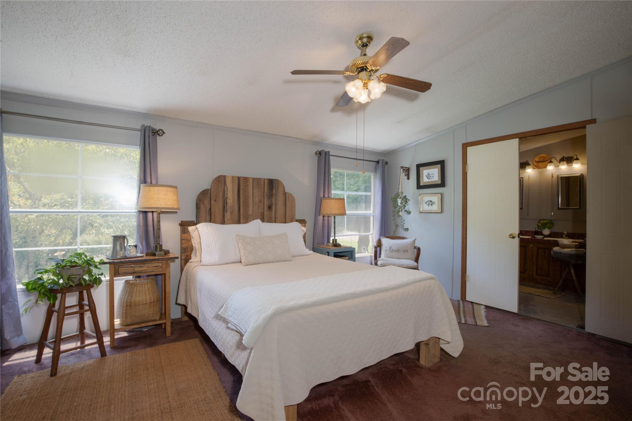 614 Upper Doe Bag Road Green Mountain, NC 28740 - Photo 36 of 44 a bedroom with a bed and a chandelier