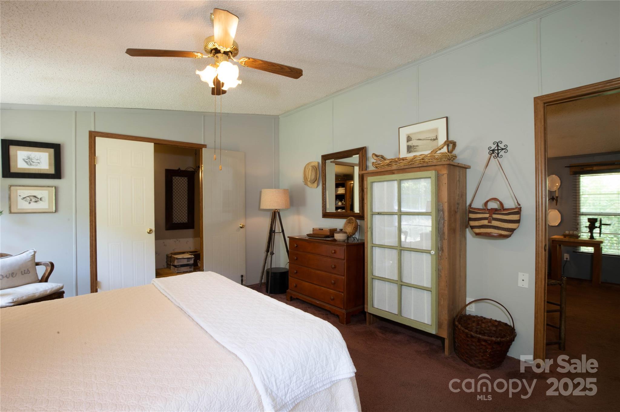 614 Upper Doe Bag Road Green Mountain, NC 28740 - Photo 38 of 44 a bedroom with a bed and a chandelier