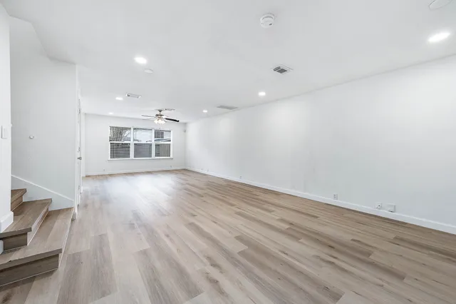 a view of wooden floor and windows in a room