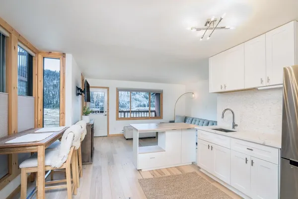 a kitchen with cabinets a sink and appliances
