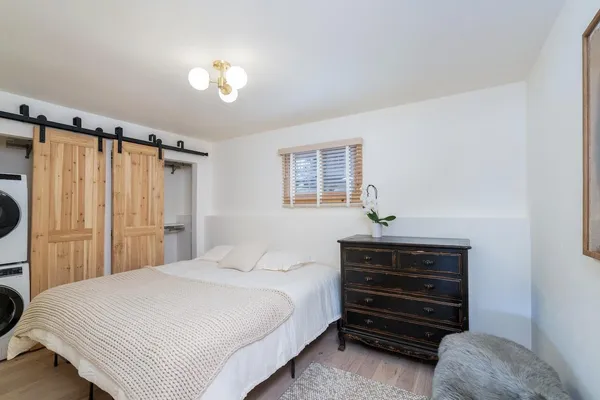 a bedroom with a bed and a chandelier