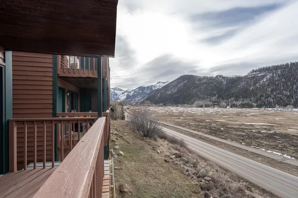 a view of balcony with wooden floor and fence