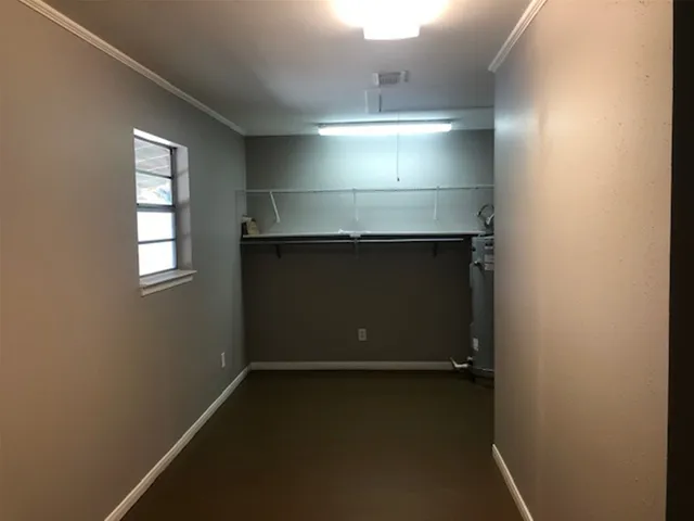 a view of storage and utility room with racks on the wall
