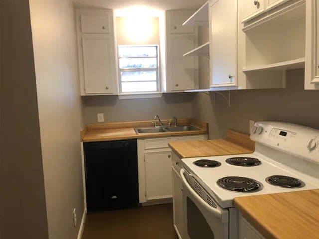 a kitchen that has a sink a stove and a window