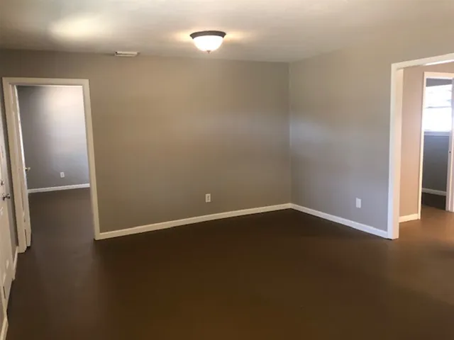 a view of an empty room with closet area