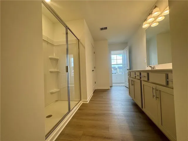 a view of a hallway with wooden floor