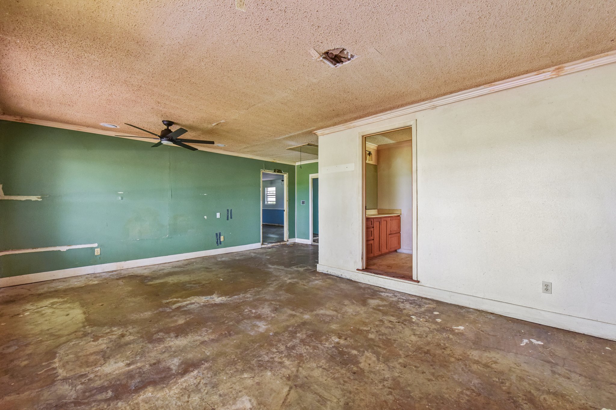 1111 Silent Valley Road Lockhart, TX 78644 - Photo 8 of 14 A spacious room offers potential for transformation with a clear layout and connecting spaces.