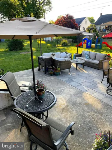 a backyard of a house with table and chairs