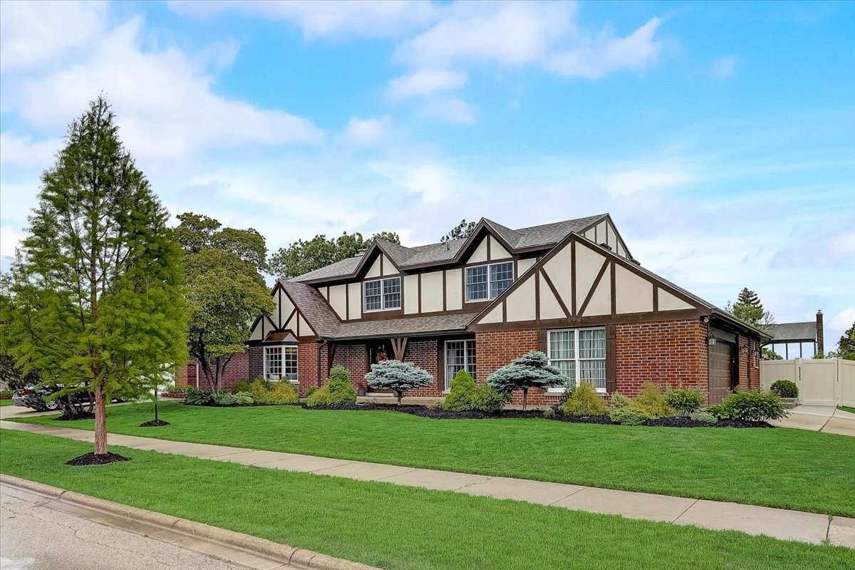 4365 Phyllis Drive Northbrook, IL 60062 - Photo 2 of 55 a front view of a house with a garden and trees