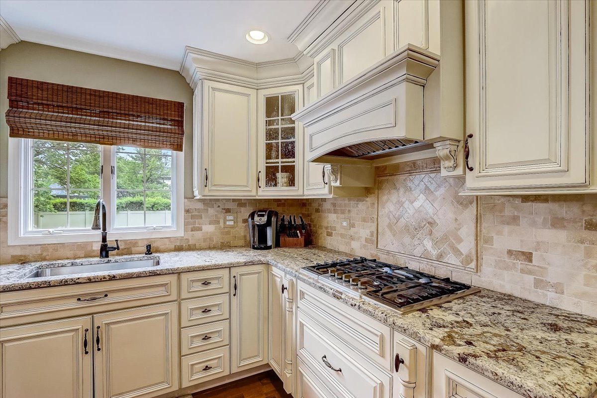 4365 Phyllis Drive Northbrook, IL 60062 - Photo 21 of 55 a kitchen with a stove a sink and a window
