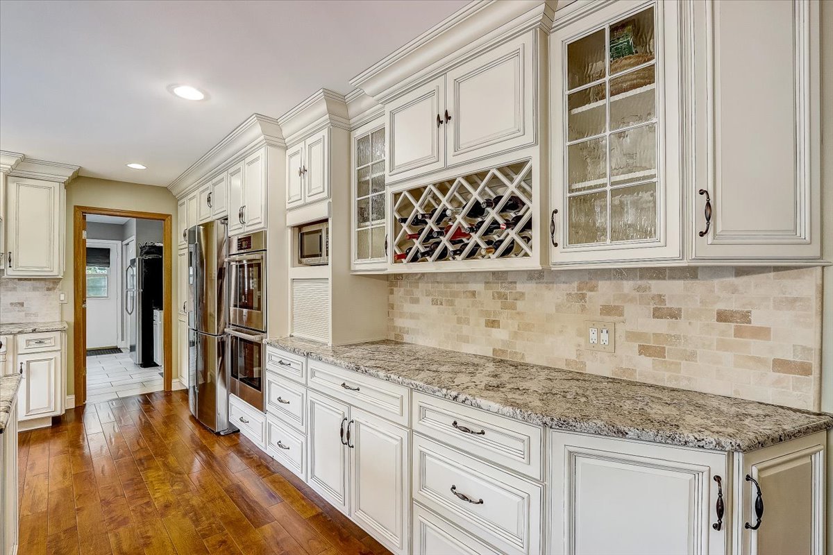 4365 Phyllis Drive Northbrook, IL 60062 - Photo 22 of 55 a kitchen with stainless steel appliances granite countertop a sink and cabinets