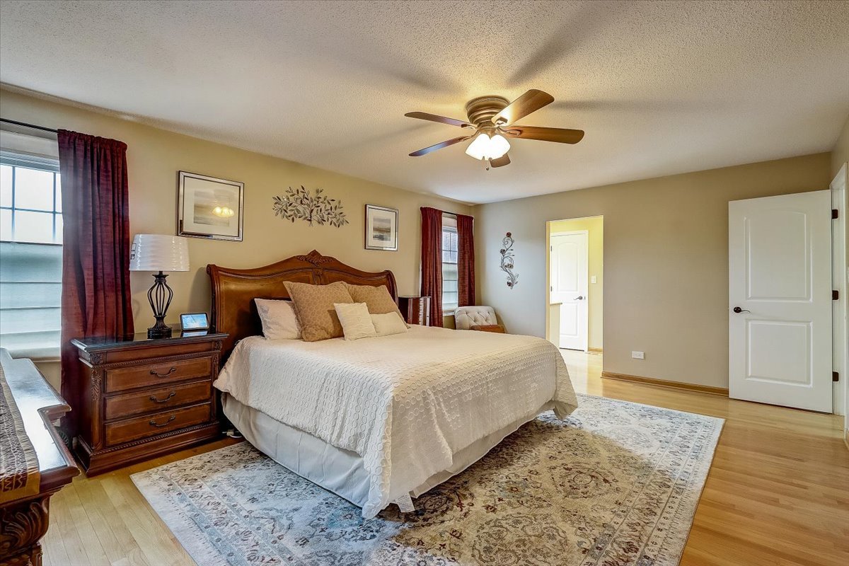 4365 Phyllis Drive Northbrook, IL 60062 - Photo 29 of 55 a bedroom with a bed and wooden floor