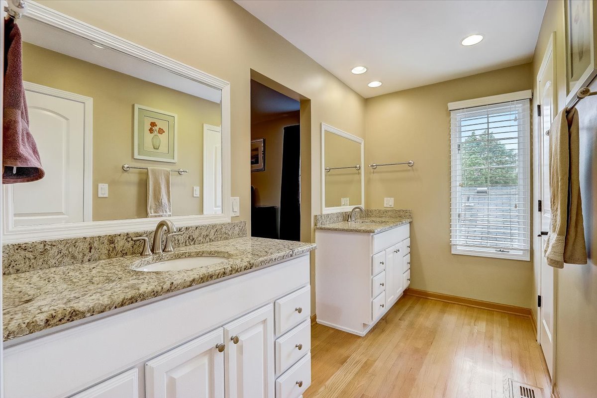4365 Phyllis Drive Northbrook, IL 60062 - Photo 31 of 55 a bathroom with a granite countertop sink mirror and a bath tub