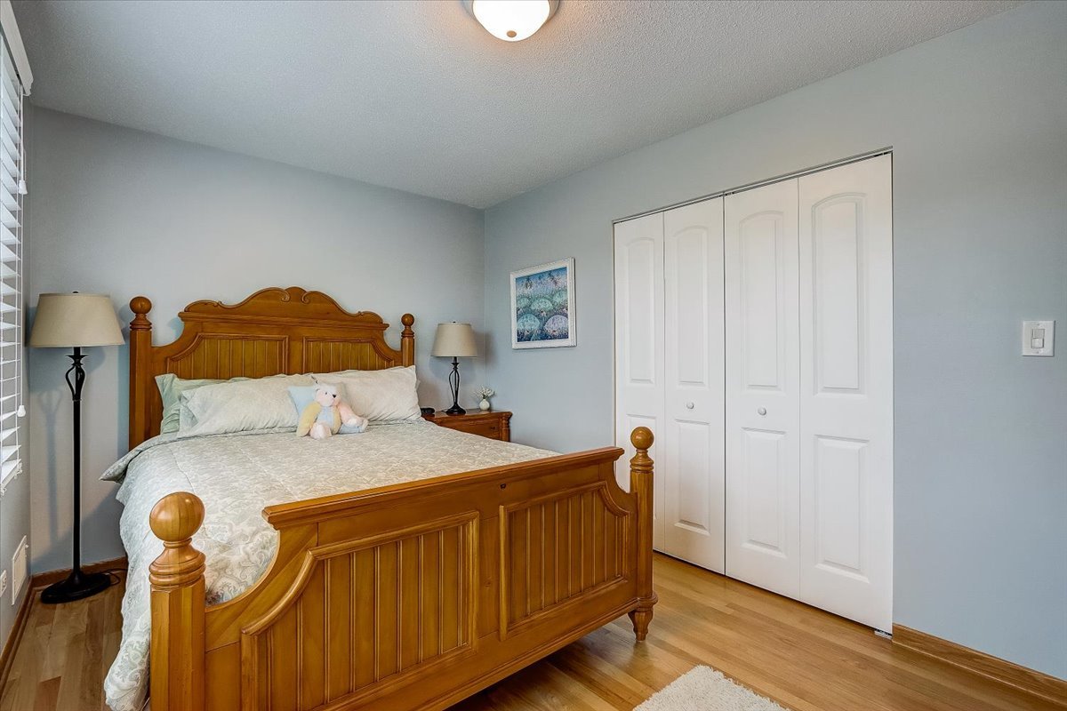 4365 Phyllis Drive Northbrook, IL 60062 - Photo 34 of 55 a bedroom with a bed and wooden floor