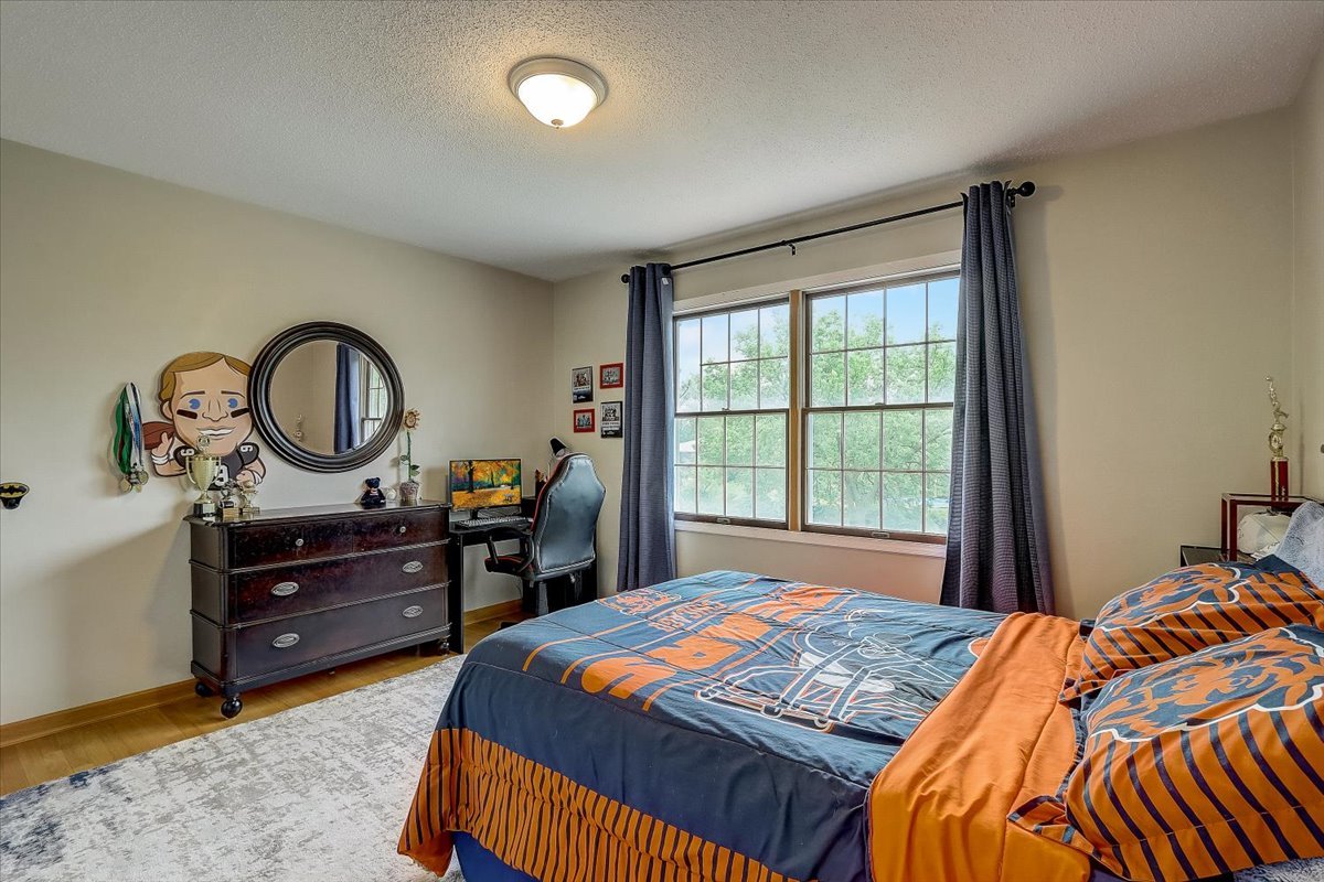 4365 Phyllis Drive Northbrook, IL 60062 - Photo 38 of 55 a bedroom with a bed and a dresser in it