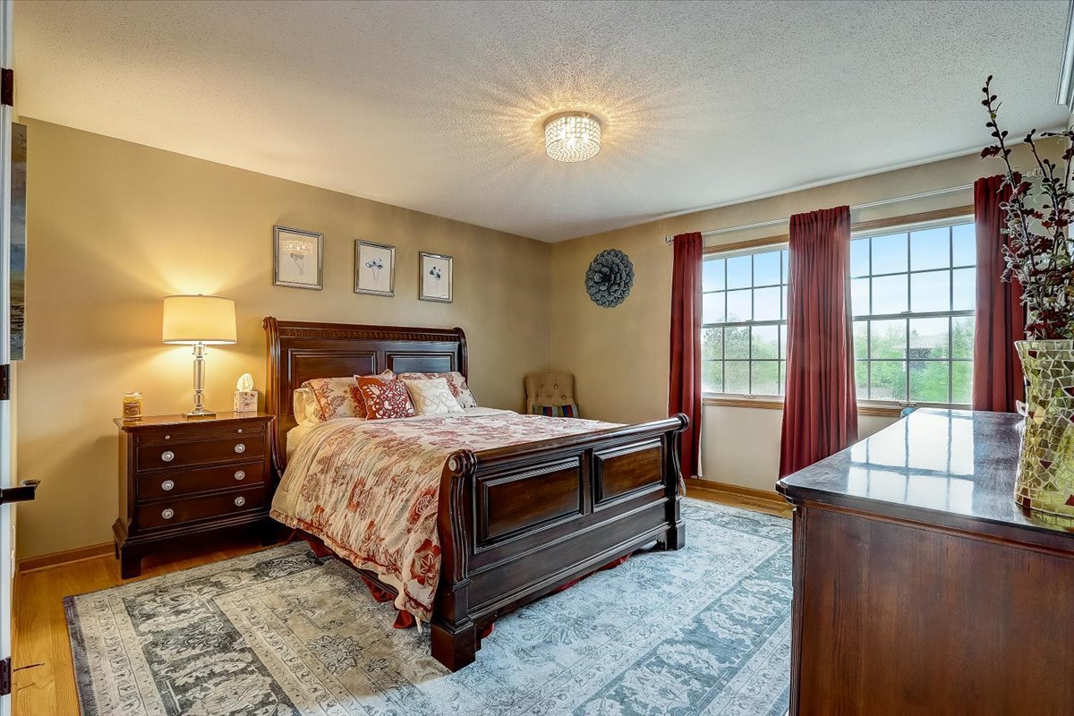 4365 Phyllis Drive Northbrook, IL 60062 - Photo 40 of 55 a bedroom with a bed and a dresser next to a window