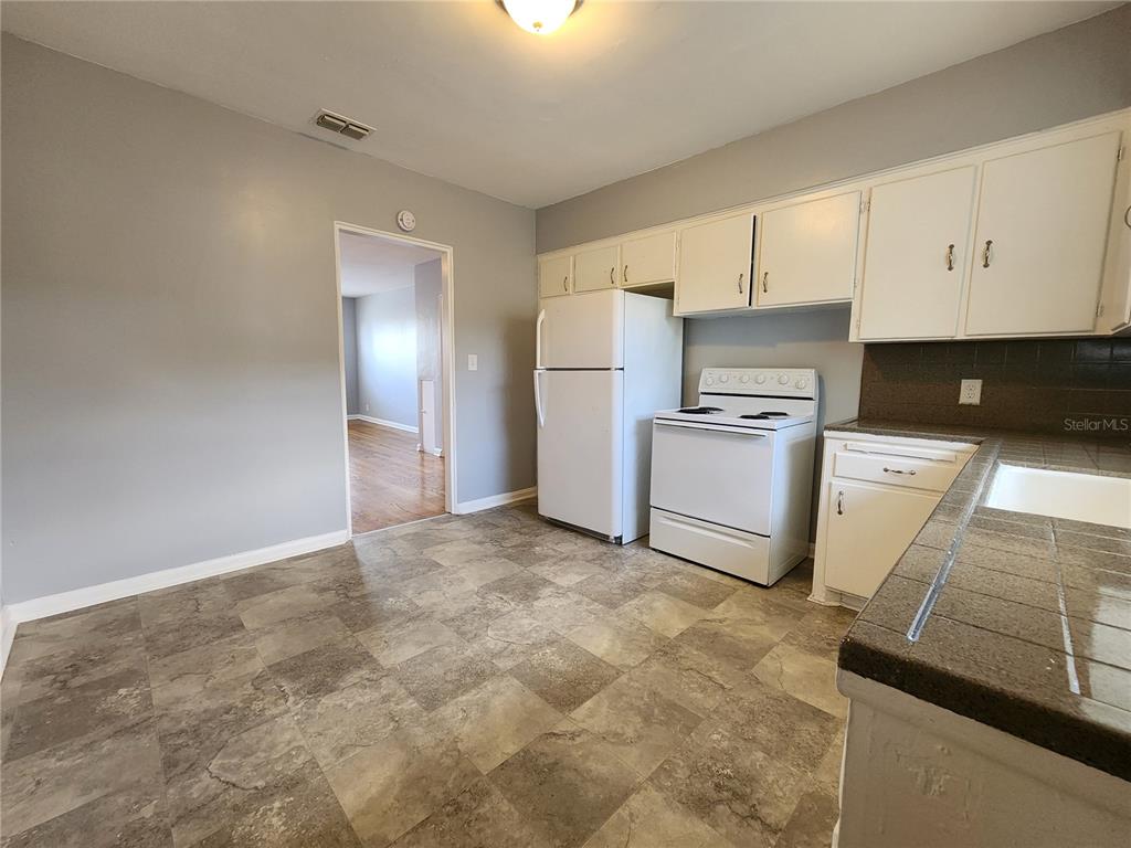 3148 Belden Street, Unit 3 Jacksonville, FL 32207 - Photo 4 of 4 a kitchen with a stove a sink and a refrigerator