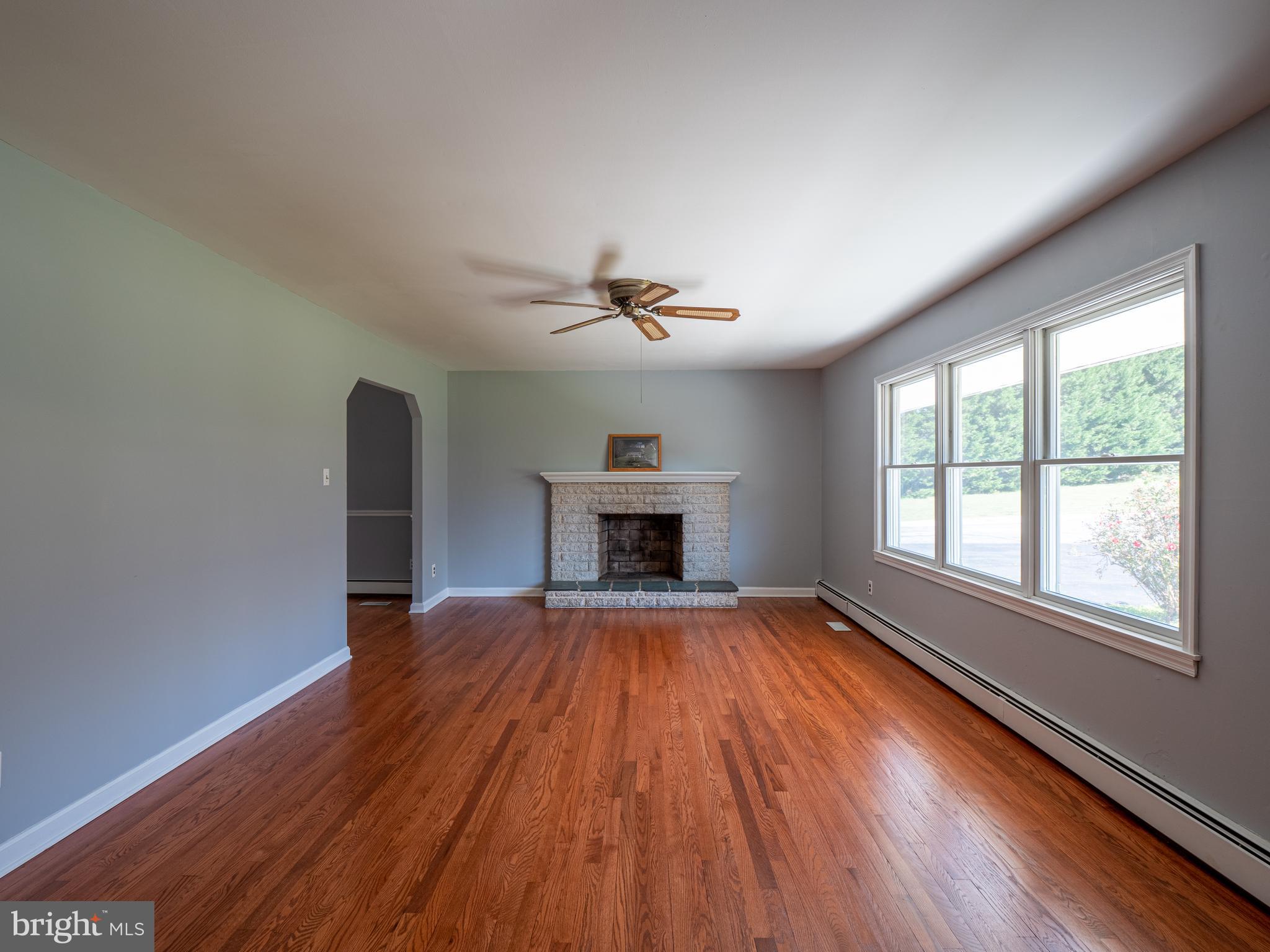 580 Plum Point Road Huntingtown, MD 20639 - Photo 10 of 48 Living room with wood burning fireplace