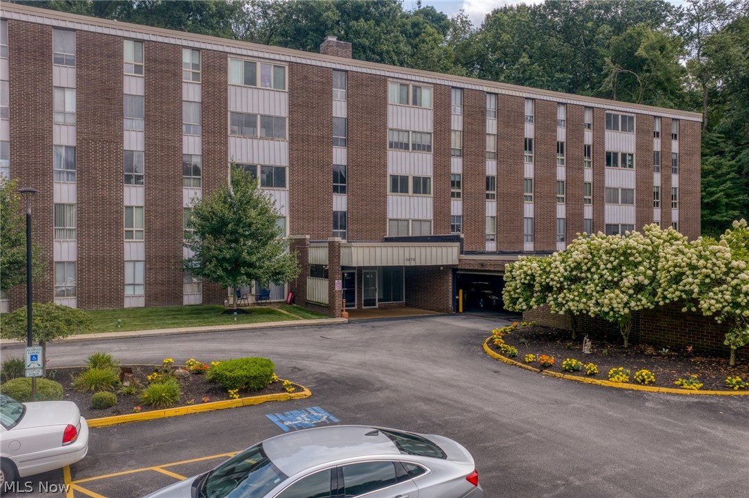 3070 Kent Road, Unit 312D Stow, OH 44224 - Photo 49 of 49 Brick facade building featuring multiple levels, an integrated covered entrance, and a paved parking area