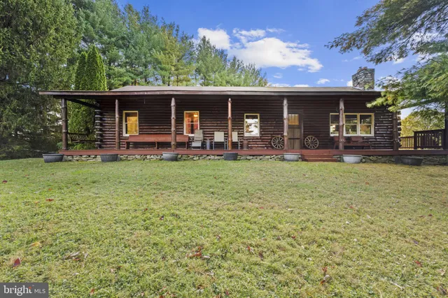 front view of a house with a yard table and chairs