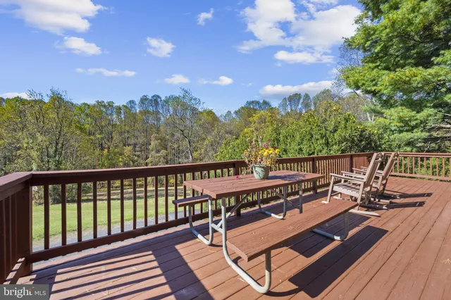 a view of a balcony with chairs and wooden floor