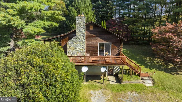 a view of house with swimming pool and sitting area