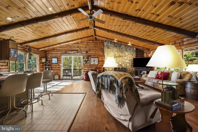 a view of a patio with table and chairs with wooden floor and fence