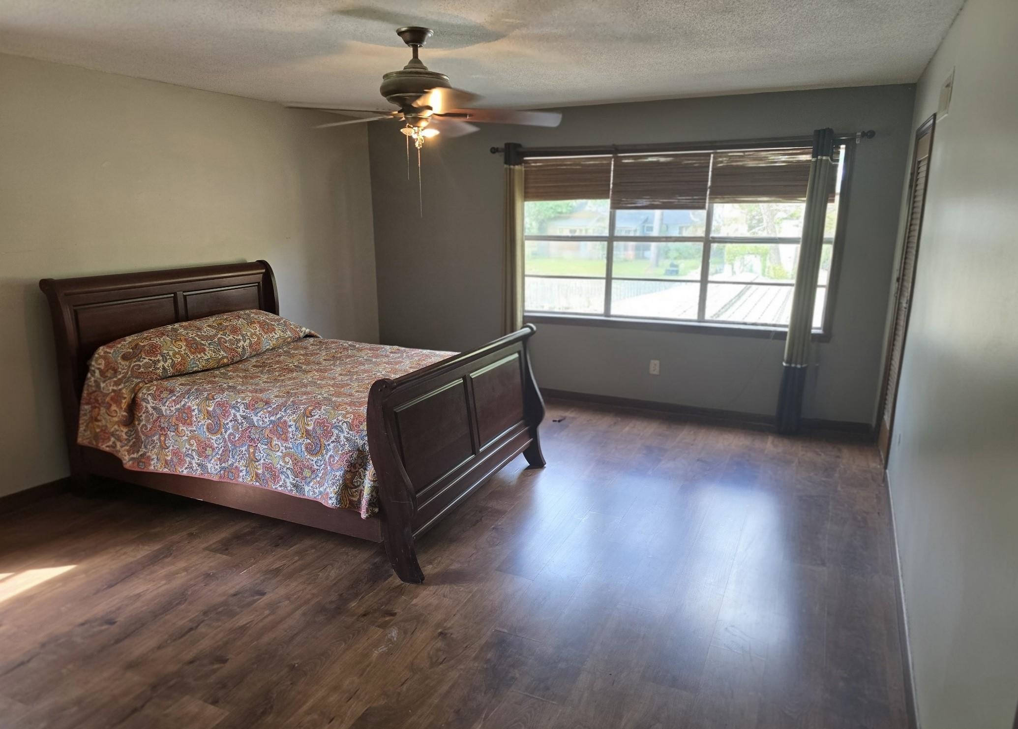 8724 Fay Road Memphis, TN 38018 - Photo 12 of 26 Bedroom with dark wood-style floors, a textured ceiling, and a ceiling fan