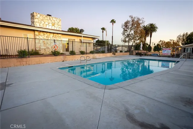 a swimming pool with outdoor seating and yard