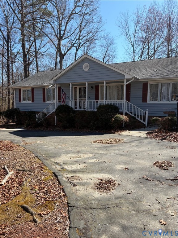 a front view of a house with a yard covered in snow