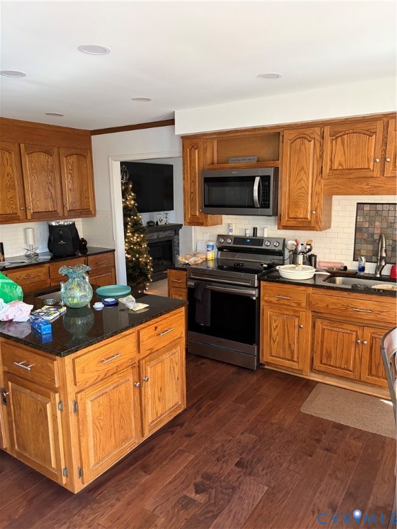 4603 Edenton Place Chester, VA 23831 - Photo 5 of 8 a kitchen with stainless steel appliances granite countertop a stove top oven a sink dishwasher a dining table and chairs with wooden floor