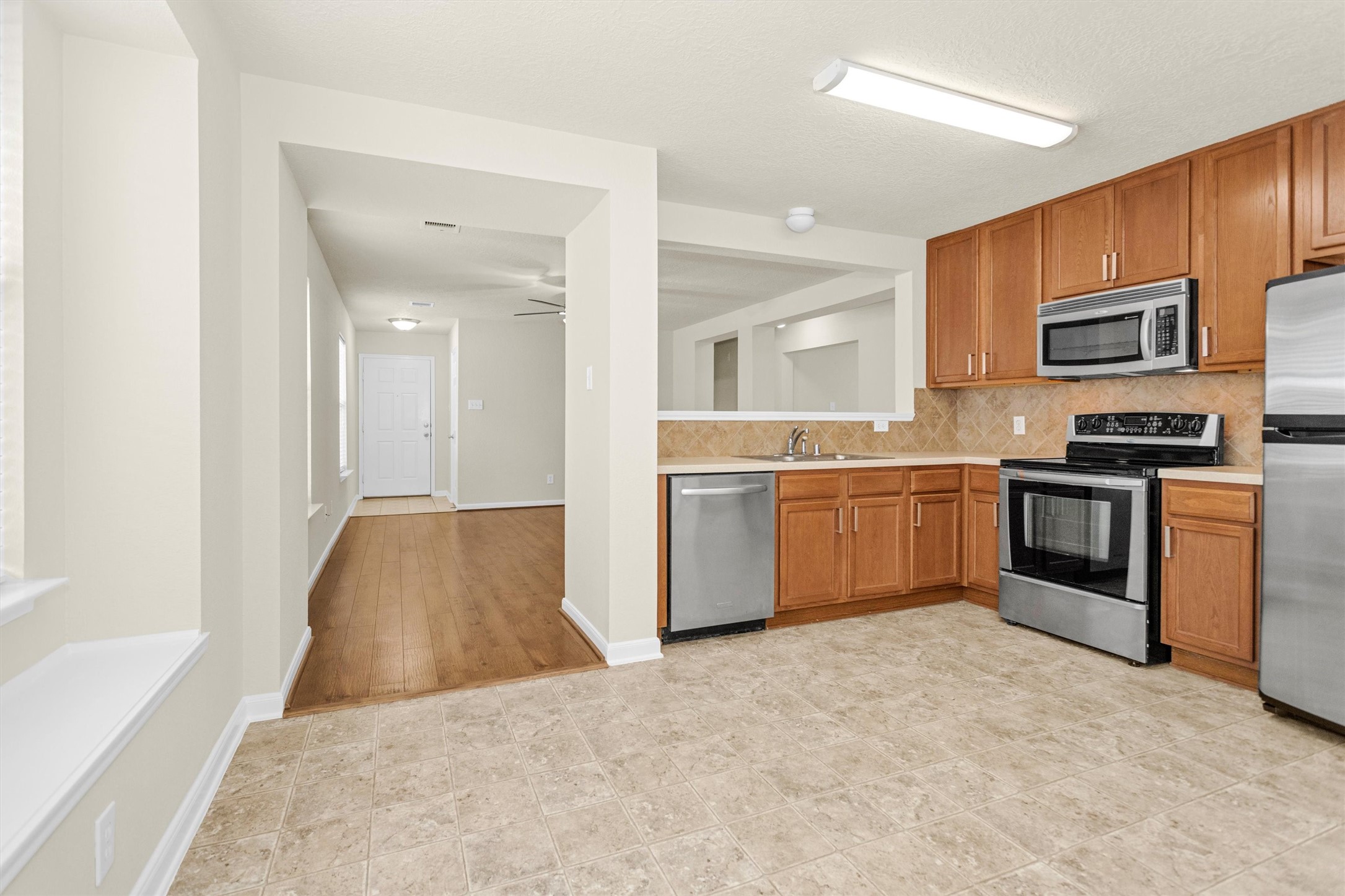 3131 Beacon Grove Street Spring, TX 77389 - Photo 11 of 38 a kitchen with stainless steel appliances a sink and a refrigerator