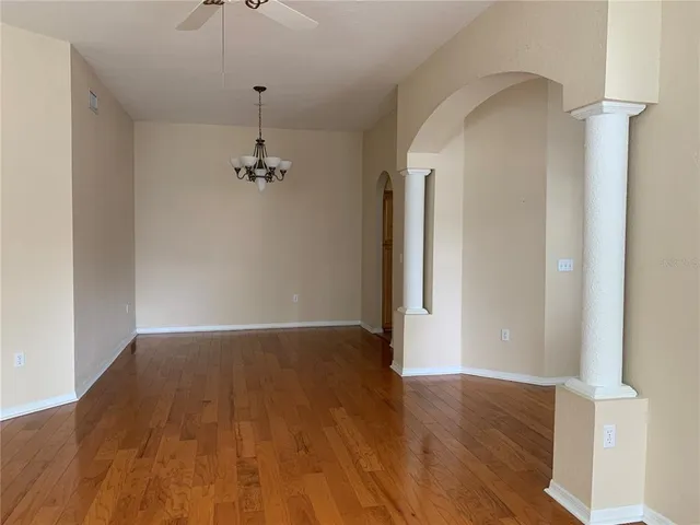 a view of a room with wooden floor and carpet