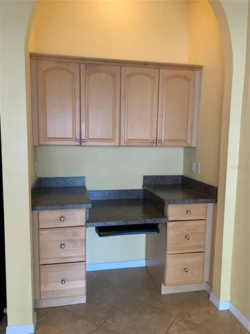 a kitchen with white cabinets and a stove