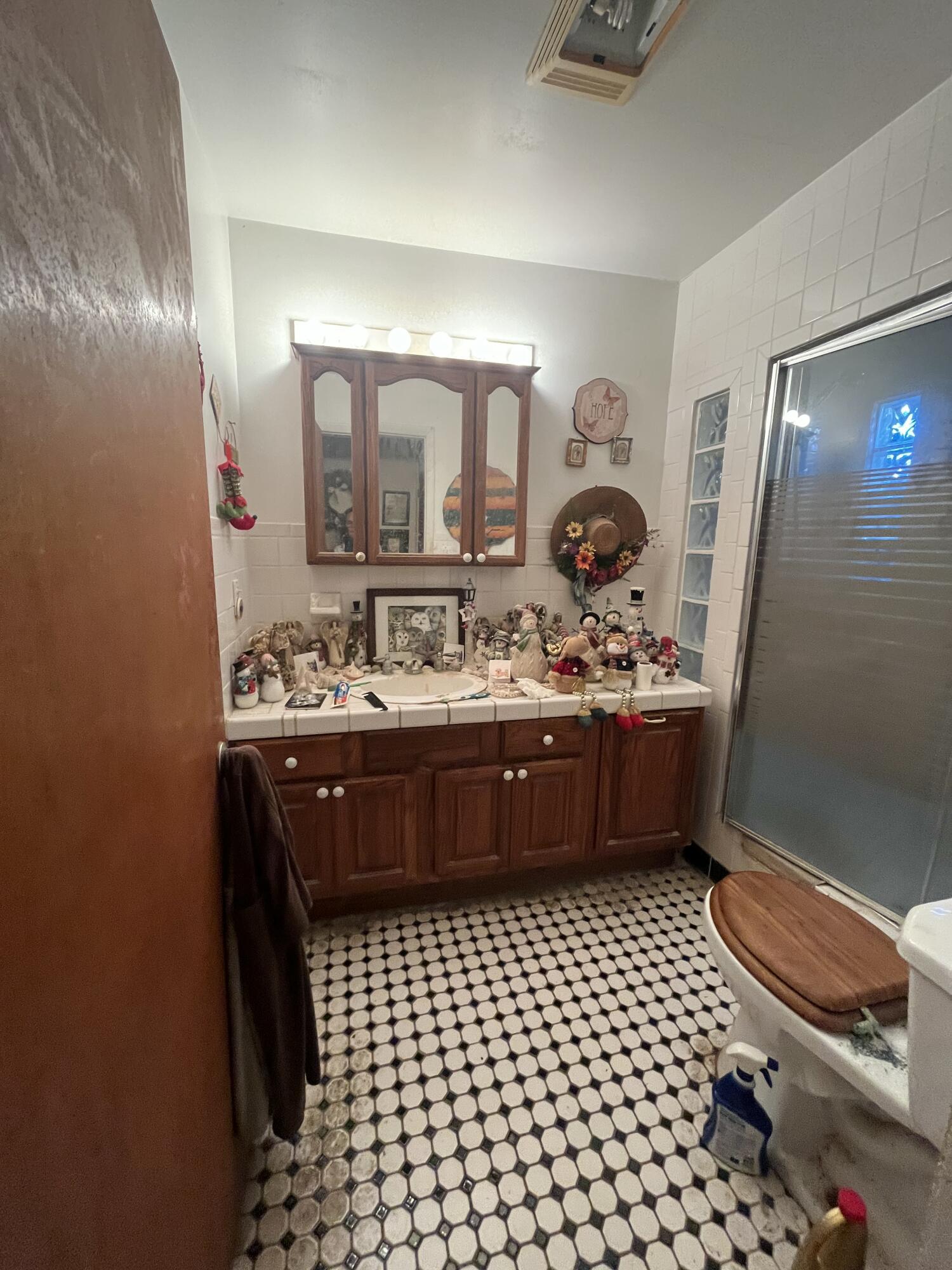 907 Virginia Street Key West, FL 33040 - Photo 19 of 19 a bathroom with a sink a toilet and mirror