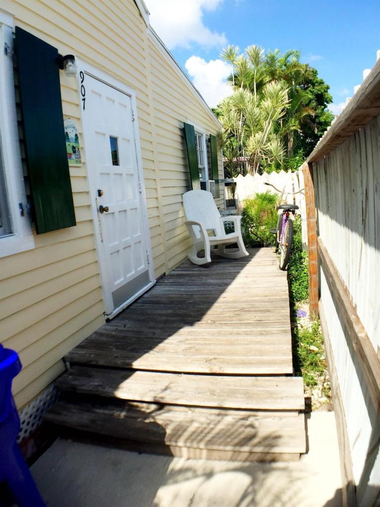 907 Virginia Street Key West, FL 33040 - Photo 2 of 19 a view of a two chair in the balcony