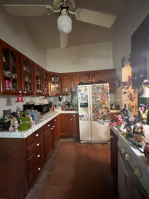 907 Virginia Street Key West, FL 33040 - Photo 6 of 19 a kitchen with stainless steel appliances kitchen island granite countertop a stove refrigerator and cabinets
