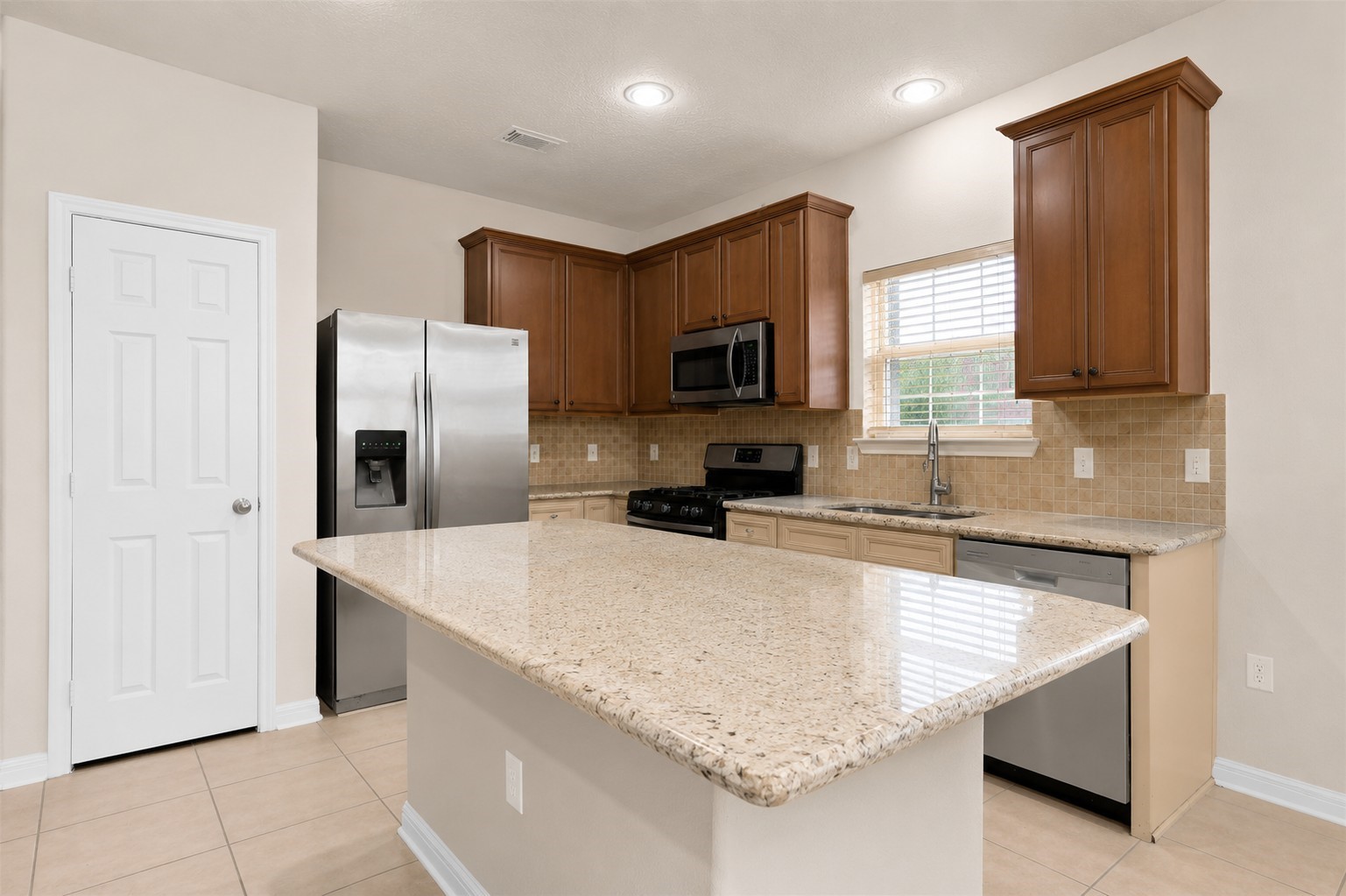 1443 Meadowhigh Lane Spring, TX 77373 - Photo 5 of 23 a kitchen with stainless steel appliances granite countertop a sink refrigerator and microwave