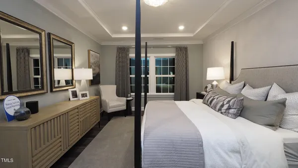 a large bedroom with bed and a large window